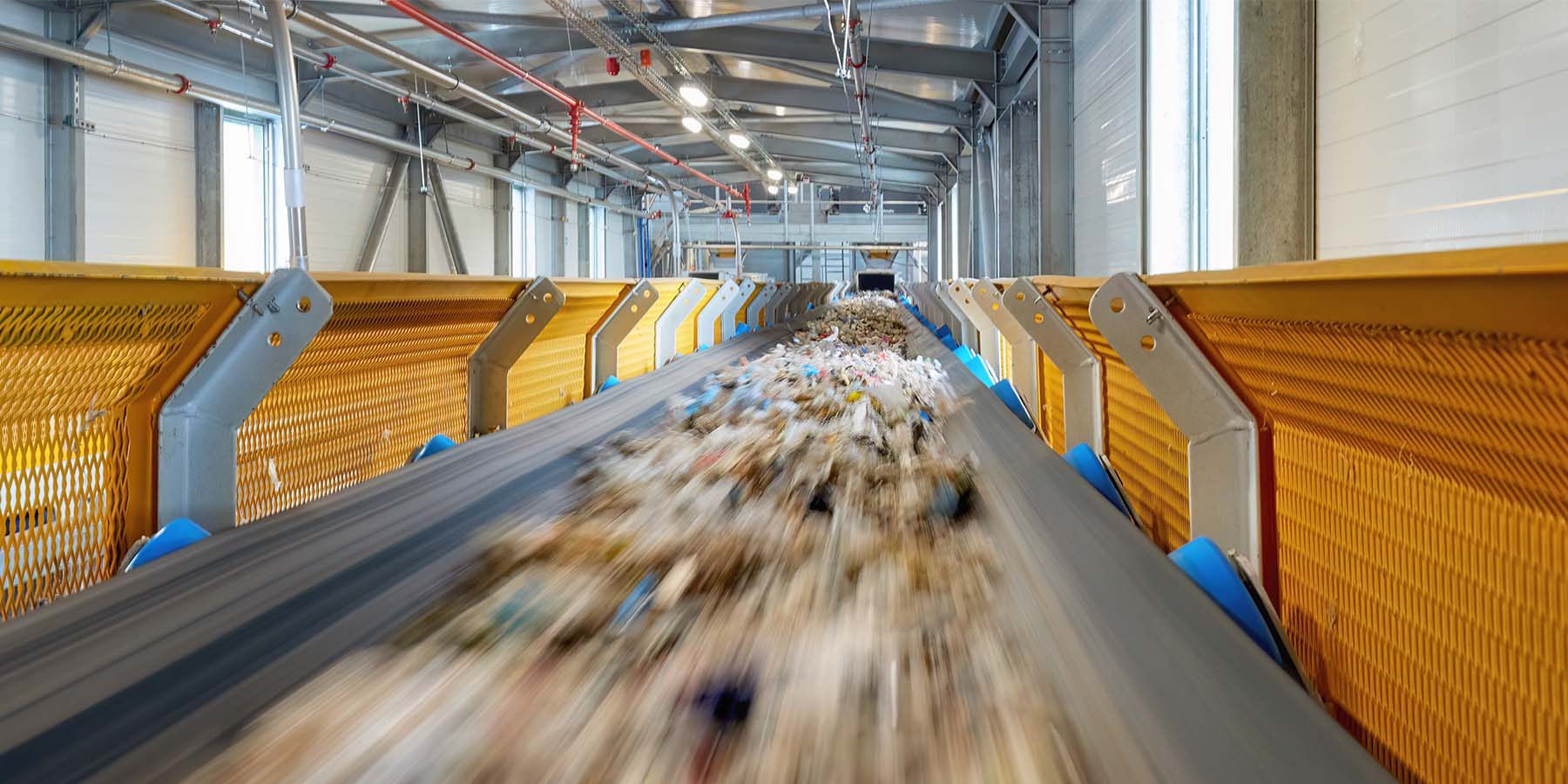 conveyor belt with recyclable material in a factory